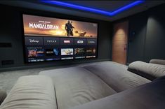 a large screen tv mounted to the side of a wall in a home theater room