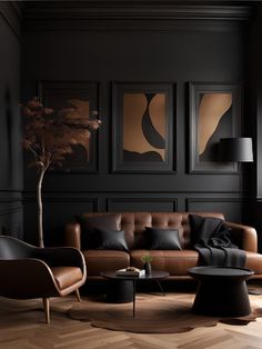 an elegant living room with black walls and leather couches, coffee table, lamps, and paintings on the wall