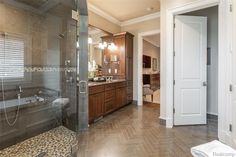 a bathroom with a walk in shower next to a bathtub and sink area on the side