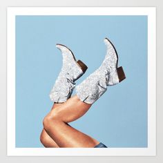 a woman's legs and shoes are shown in front of a blue sky art print