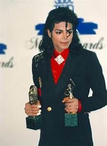 michael jackson holding two awards in his hands