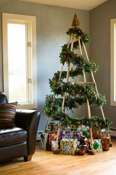 a christmas tree with presents under it in a living room