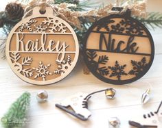 two wooden ornaments with name and snowflakes on them