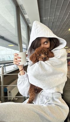 a woman holding a dog in her arms