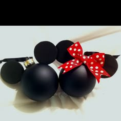 two mickey mouse heads with a red bow on them