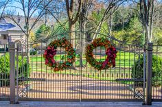 two wreaths that are on top of a gate