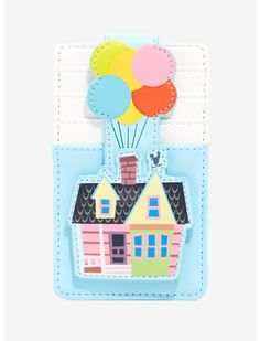 a card with a house and balloons on it