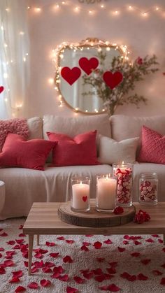 a living room filled with lots of white furniture and red pillows on top of it