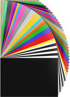 an assortment of different colored papers on top of each other, with one black square in the middle