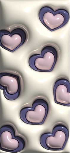 some hearts are in the middle of a white and purple pattern on a tile wall