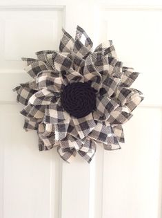 a black and white flower is hanging on the door