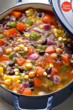 a pot filled with soup and vegetables on top of a table