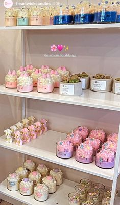 a shelf filled with lots of cakes and cupcakes on top of it's shelves