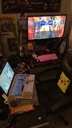 a laptop computer sitting on top of a desk next to a tv monitor and keyboard