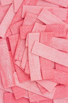 a pile of pink crayon paper on top of each other