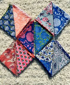 six different colored handkerchiefs laid out on the floor