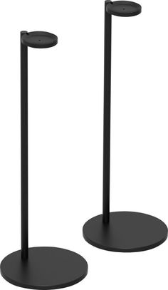 two black metal poles are standing next to each other on the same pole, one is round