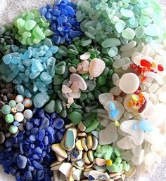 many different colored rocks and pebbles on the ground