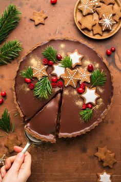 someone is decorating a chocolate cake with christmas decorations on the top and bottom half