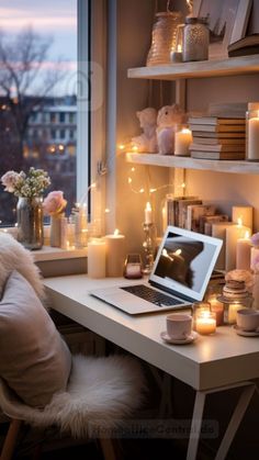 a laptop computer sitting on top of a desk in front of a window filled with candles