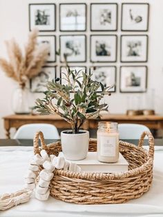 a wicker basket with candles and plants in it