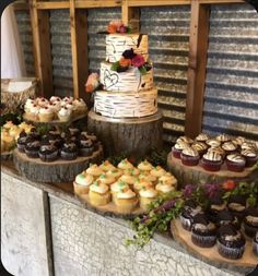 a table topped with lots of cupcakes and cakes