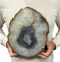 a person holding a piece of agate in their hands