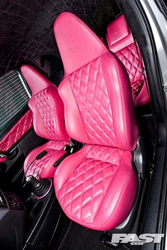 the interior of a car with pink leather seats and matching floor mats is shown in this image