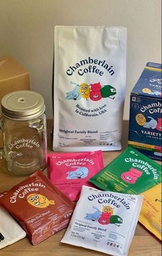 the contents of a variety of coffees are displayed on a wooden table next to a bag of coffee