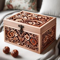 an intricately carved wooden box sits on a bed with two matching cufflinks