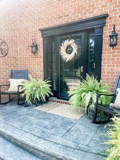 the front door is decorated with wreaths and plants