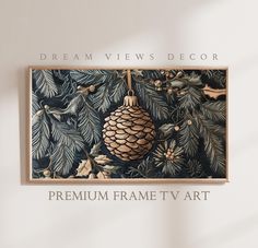 a pine cone hanging from the side of a wooden frame on a wall with text that reads, dream views decor premium frame tv art