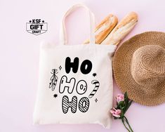 a tote bag with the words ho ho ho on it next to some bread