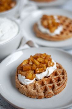 some waffles with fruit on top and whipped cream