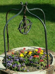 an old iron pot with flowers in it