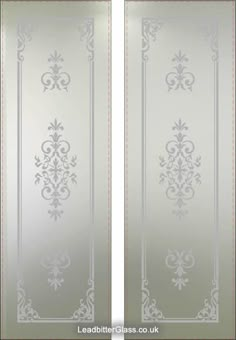 two glass doors with decorative designs on the front and back panels, both in silver