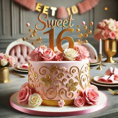 a pink and gold birthday cake with flowers on the top is surrounded by other decorations