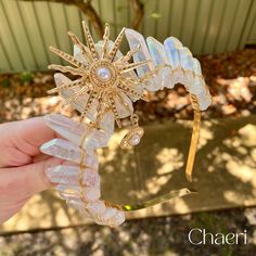 Andromeda | Clear Crystal Quartz Crown with Golden Sun Charm Inspired by Greek mythology, the Andromeda Crystal Crown dazzles with shimmering crystals, embodying the grace of a legendary princess.  An ideal accessory for any special event. ★ Aura Clear Quartz ★ - Emotional healing - Radiating positive energy - Spiritual growth  Follow us on instagram @Chaeri_Crystal_Crowns for updates, giveaways and sales!  LEAD TIMES: * Usually, crowns and crystal products are dispatched within 2-4 business day Boho Crystal Tiara, Banqour Crystal Crown, Crystal Products, Festival Crown, Quartz Crown, Crystal Crowns, Sun Charm, Orange Crystals, Golden Sun