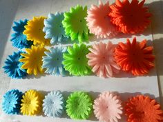 colorful felt flowers laid out on a piece of paper