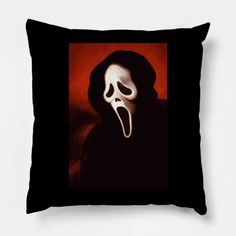 a black pillow with a white mask on it's face in front of a red background