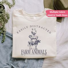 a t - shirt that says easily distracted by farm animals on the front and back