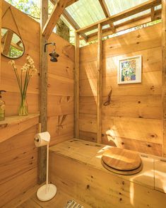 a bathroom with wood walls and wooden flooring