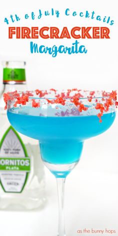 a firecracker margarita in a martini glass with confetti on the rim