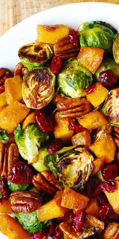 a white plate topped with brussel sprouts and brussels sprouts