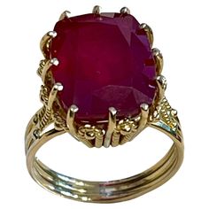 7.5 Carat Cushion Shape Treated Ruby 14 Karat Yellow Gold Ring Size 5.5 Multiple prong set 14 K Yellow Gold: 7.0 gram Ring Size 5.5 ( can be altered for no charge ) This ring is on clearance and is priced very competitively. It's a vintage piece with gold frame work, adding to its charm and value. While the pictures are from a phone and not professional, the actual piece is even prettier in person. If you need the ring resized, it can be done for free of charge, but once it's resized to your siz Formal Cabochon Ruby Ring, Formal Ruby Ring With Diamond Cut In Yellow Gold, Formal Yellow Gold Ruby Ring With Cabochon, Vintage Gia Certified Ruby Ring For Formal Occasions, Elegant Gia Certified Gold Ruby Ring, Exquisite Diamond Cut Ruby Ring For Formal Occasions, Formal Gia Certified 14k Gold Ruby Ring, Luxury Hallmarked Ruby Ring For Formal Occasions, Formal Yellow Gold Ruby Ring