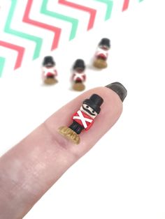 a finger with a small toy soldier on it