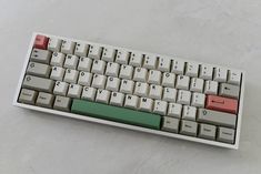 a computer keyboard sitting on top of a white table