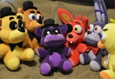 a group of stuffed animals sitting on top of a couch