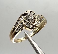 a diamond ring is being held by a pair of scissors