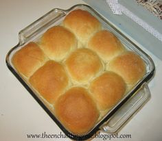 a glass dish filled with bread on top of a white counter next to a box